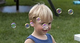 Child with bubbles at Rockin' Block Party
