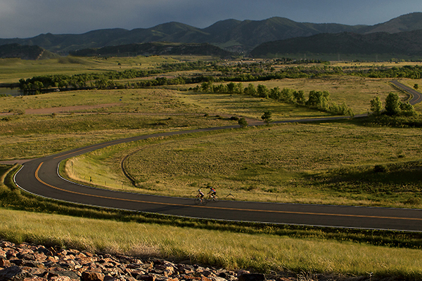 Two bikers head along a Bear Creek Lake Park road.