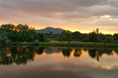 A sunset takes place over Bear Creek Lake.