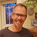 A portrait of massage therapist Greg Holland.