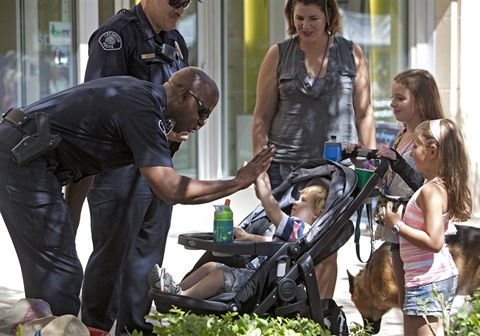 Lakewood Police Officer giving a kid a high-five.