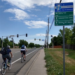 Bicyclists and Wayfinding Sign on Garrison St.