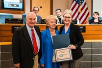 Wendi Strom posing with Doug and Judy Whitten
