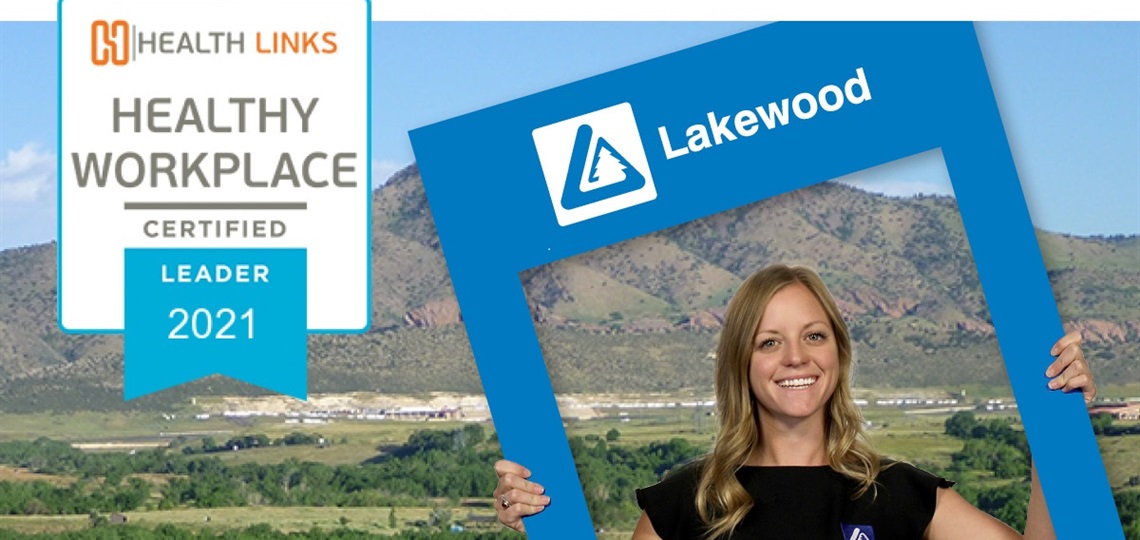 Lakewood employee holding a Lakewood sign