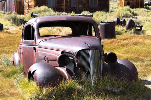 Inoperable car sitting on the lawn.